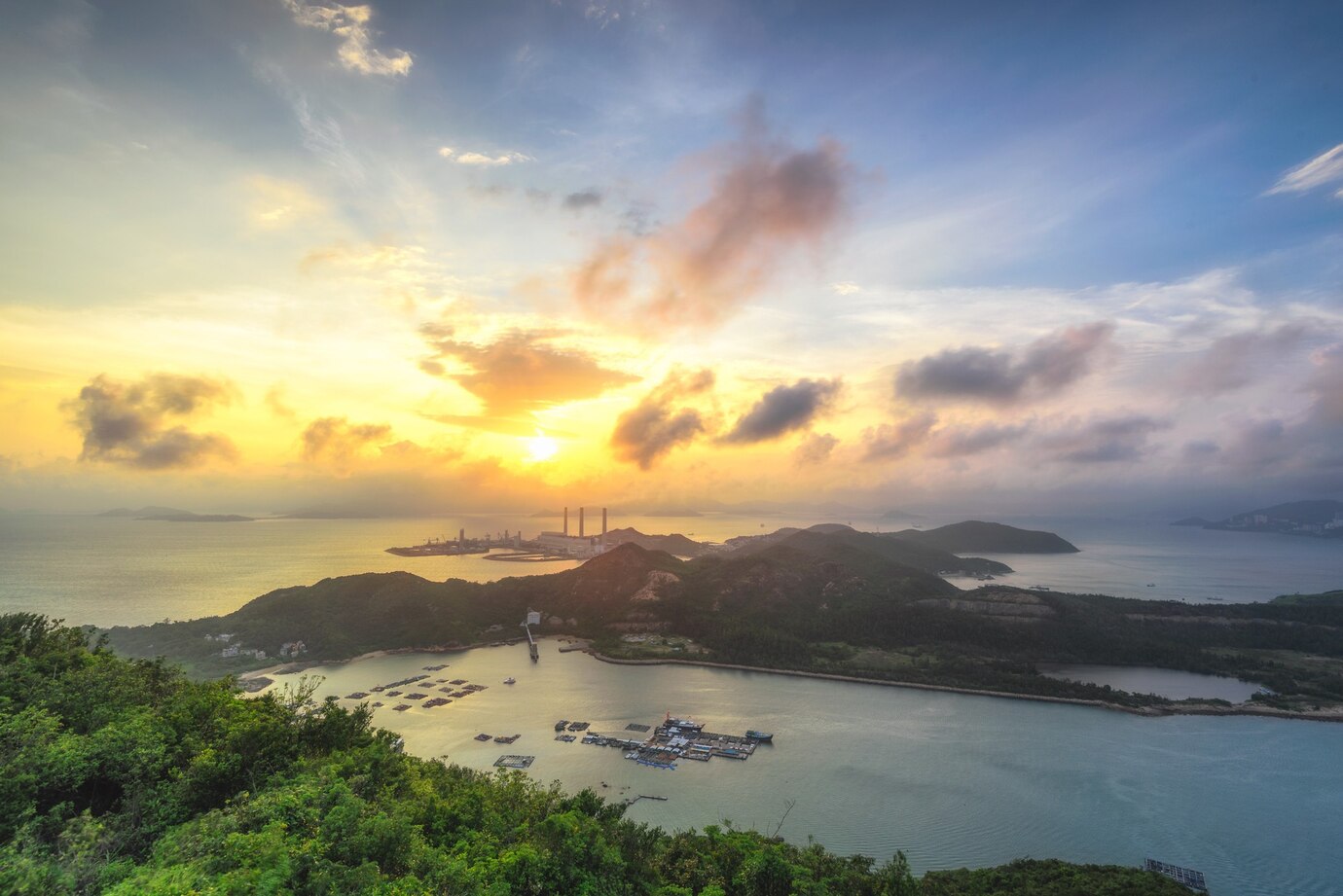 beautiful-shot-island-surrounded-by-sea-cloudy-sky-sunset_181624-41178